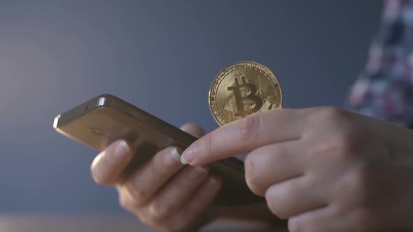 Woman Checking Bitcoin Growth Dynamics on the Phone