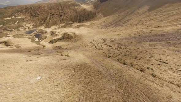 FPV Drone Footage Smooth Stabilized Fly Along Mountain Rocky Hill Around Highland Lake alt