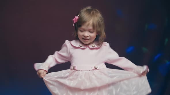Cute Little Girl in Vintage Pink Dress is Spinning in Dance and Rejoicing