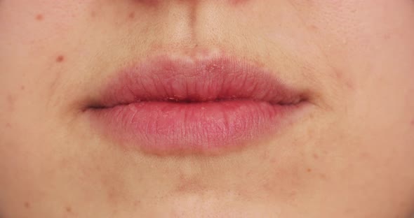 Woman's Lips Kissing in Close-up