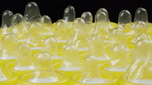 close up of many condom rotating on plate