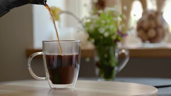 Aromatic Black Coffee is Poured Into Clear Glass Cup Geyser Coffee Maker Slow Motion alt