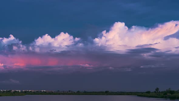 Timelapse cloudy sunset over lake