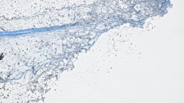 Super Slow Motion Shot of Side Water Splash Isolated on White Background at 1000Fps alt