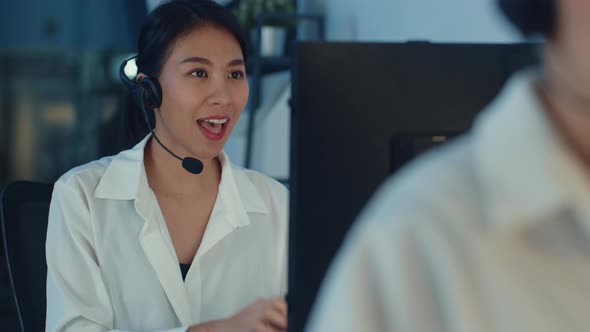 Asia young call center team or customer support service executive using computer and microphone. alt