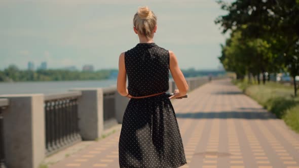 Woman Ride On Electric Scooter Mobility.E-Scooter Rider Rent Personal Eco Transport. Urban Style. alt