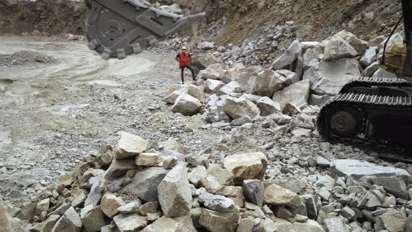 Foreman Giving Instructions to Excavator on Quarry alt