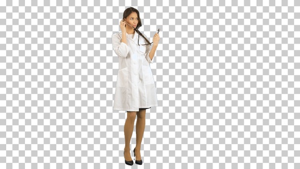 Funny female nurse playing with a stethoscope, Alpha Channel