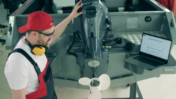 Male Worker Is Doing Maintenance Service of a Motorboat alt