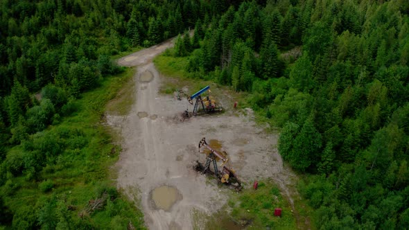 Aerial Drone View Flight Past Working Pumpjack Industrial Oil Pump Jack Working and Pumping Crude alt