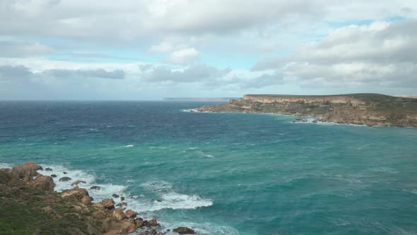 AERIAL: Ghajn Tuffieha Bay with Beautiful Turquoise Colour Sea Water on a Sunny Day alt