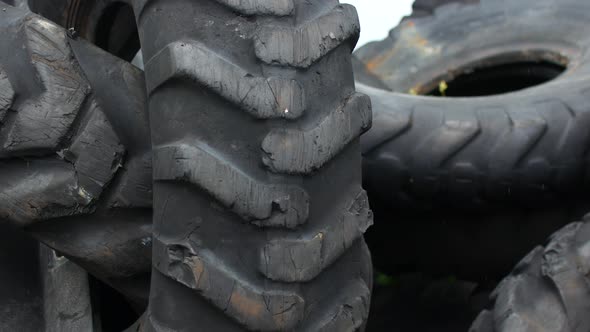 Old Leaky Tires From Trucks Piled Up in a Heap