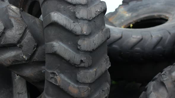 Old Leaky Tires From Trucks Piled Up in a Heap alt