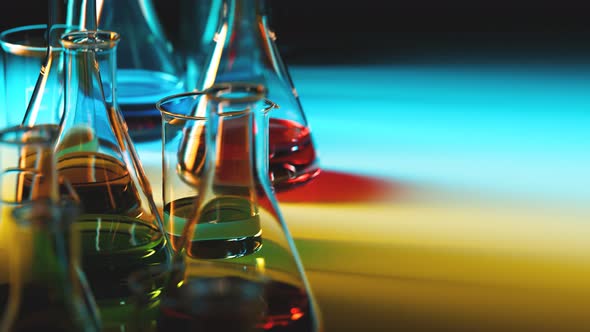 Colorful liquids in laboratory glassware. Beakers and flasks in the lab.