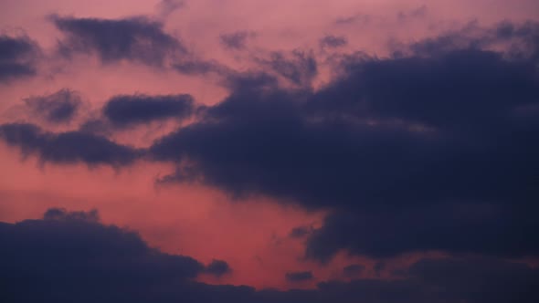 Epic stormy clouds moving fast at sunset alt