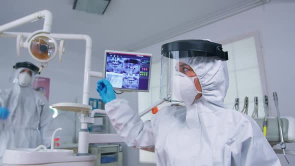 Patient Pov of Dentist in Ppe Suit Explaining Teeth Treatment alt