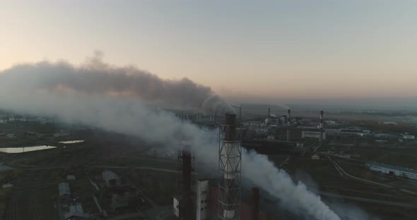 Aerial View Of High Smokestack With Smoke Emission. Plant Pipes Pollute Atmosphere. alt