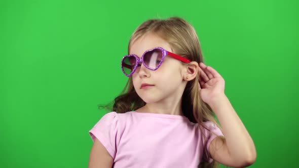 Child Posing for Video Cameras with Glasses. Green Screen. Slow Motion alt