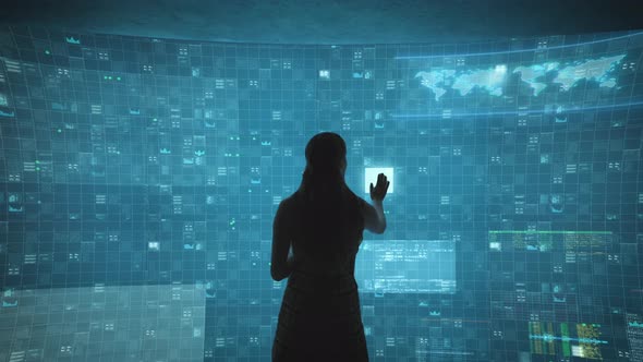 Back View of Woman Standing at Large Modern Touch Screen and Reading Information alt