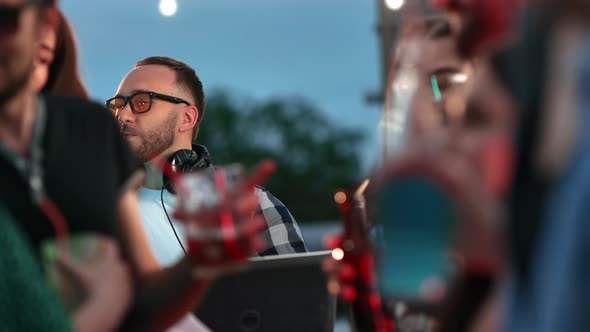 Hipster Male DJ Dancing Enjoying Music Audio Sound at Night Roof Party with Friends People Crowd alt