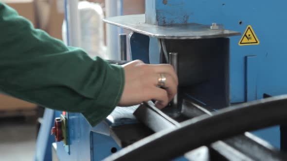 Worker Sawing Detail on Machine. Factory Worker on Circular Saw in Workshop alt