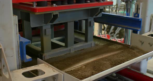 Closeup Production of a Concrete Board of Dry Vibropressing alt