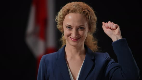 Front View Portrait of Confident Smiling Inspired Woman Showing Support Strength Gesture Looking at alt