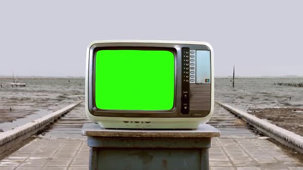Retro TV Set with Green Screen in a Flooded Ghost Town. alt