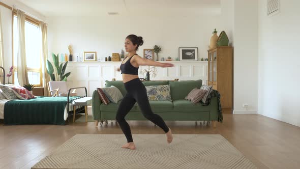 A young Indian Female Ballerina trains at home, Does a Spinning exercise, Bright Cozy Room alt