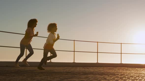 Mother and son having fun at the sunset alt