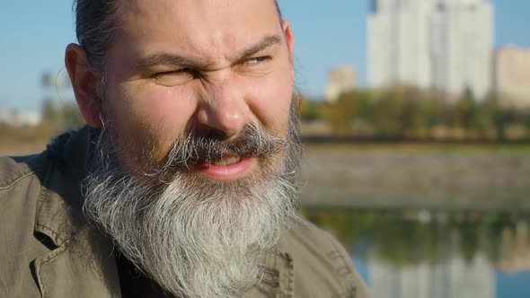 Closeup Video of a Midaged Bearded Man During Online Video Call alt