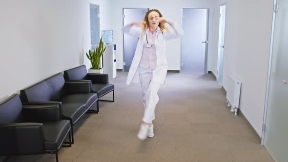 Happy and Excited Lady Doctor Dancing in Front of alt