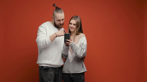 Young Couple Woman and Man Buying Online Using Smartphone and Credit Card