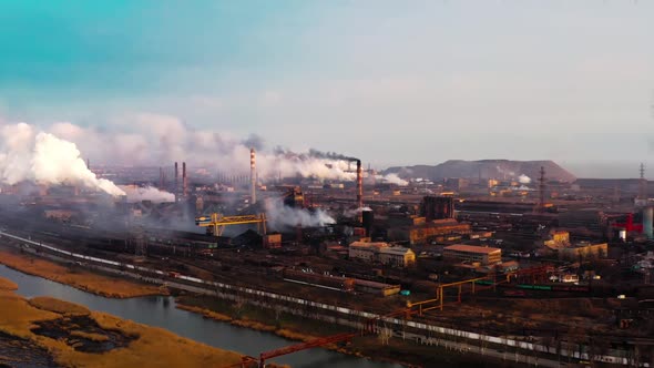 Aerial. GLOBAL WARMING. View of High Chimney Pipes with Grey Smoke. Pipes Pollute Industry alt