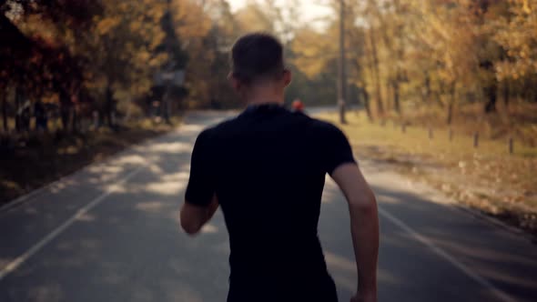 Running Man On Sea Coast Road Half Marathon. Runner Man In Sportswear Preparing To Triathlon. alt