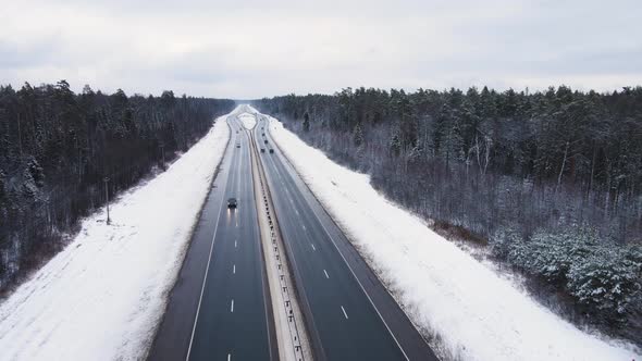 Winter Asphalt Road with Moving Cars Outside the City Aerial View alt