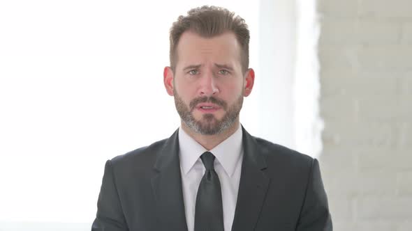 Middle Aged Businessman Looking at the Camera Sad Expression alt