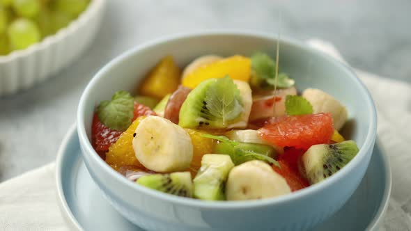 Close-up of a bowl of fruit salad with honey poured on it