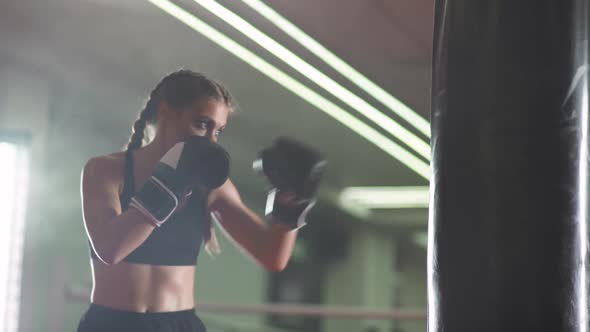 Boxing Woman Fighter Trains His Punches Beats a Punching Bag Training Day in the Boxing Gym Strength alt