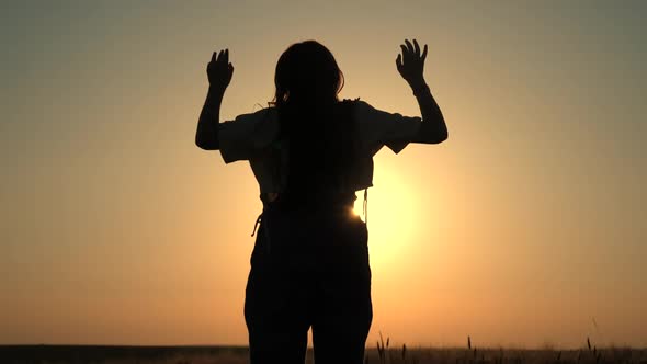 Girls enjoy nature, jumping, dancing in fields on sunset. Slow motion.