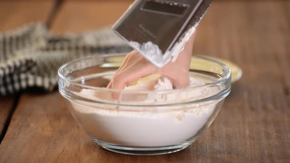 Cook Grated Butter on White Flour in a Pink Mask. Female Hands Preparing the Dough for Baking. alt