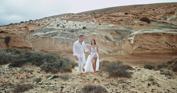 Guy and Lady Walking Through the Rocks in Amazing alt