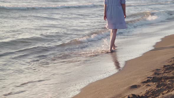 Woman Walking On Beach