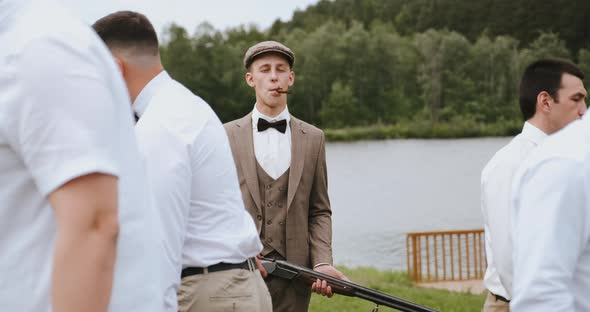 Group of Men Friends Gangsters Central Man Carries a Gun on His Shoulder