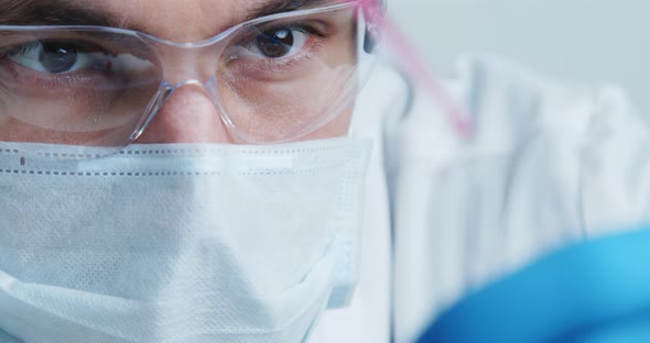 Technician Carefully Drips the Solution From the Pipette Into Glass Tubes alt