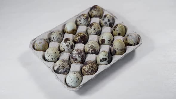 Rotating Quail Eggs On A White Background