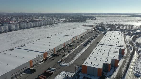 Logistics warehouse is huge. Loading trucks with goods on a ramp