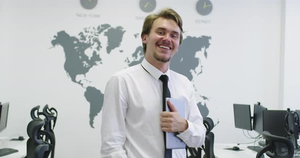Businessman Using Tablet Computer and Looking at Camera alt
