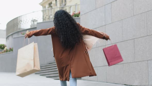 Back View From Behind Happy Cheerful Young Girl Buyer Woman Consumer Female Shopper Walking Street alt