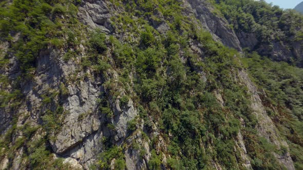 Aerial Shot Sport Fpv Drone Cliff Mountain Covered By Dense Green Trees Abkhazia Yupsharsky Canyon alt